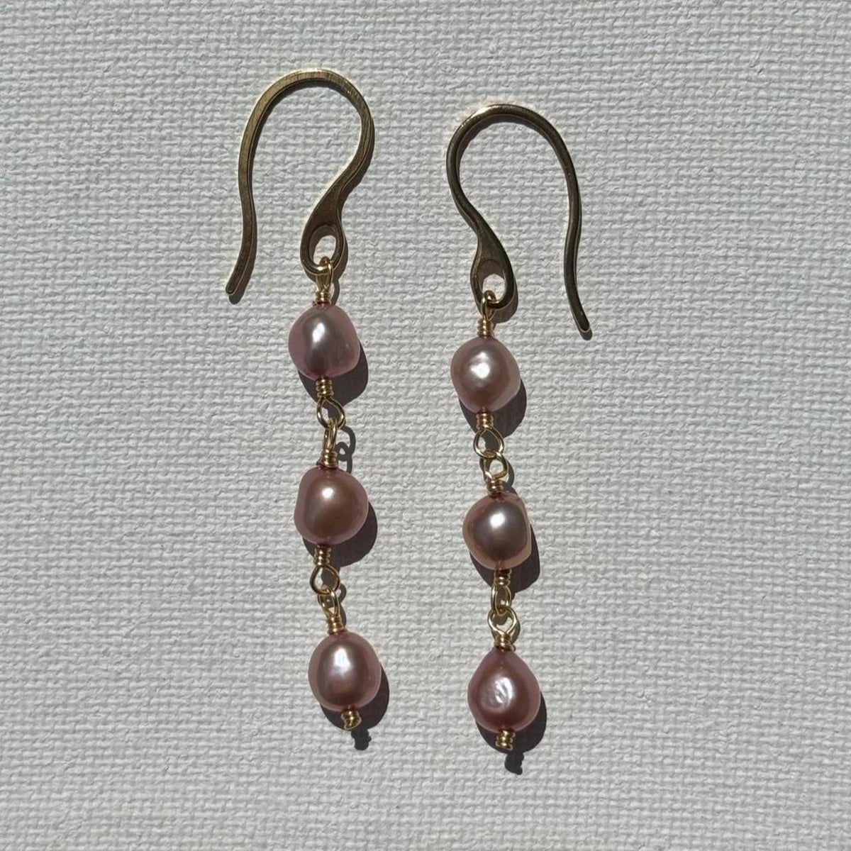 Pink pearl drop earrings in gold