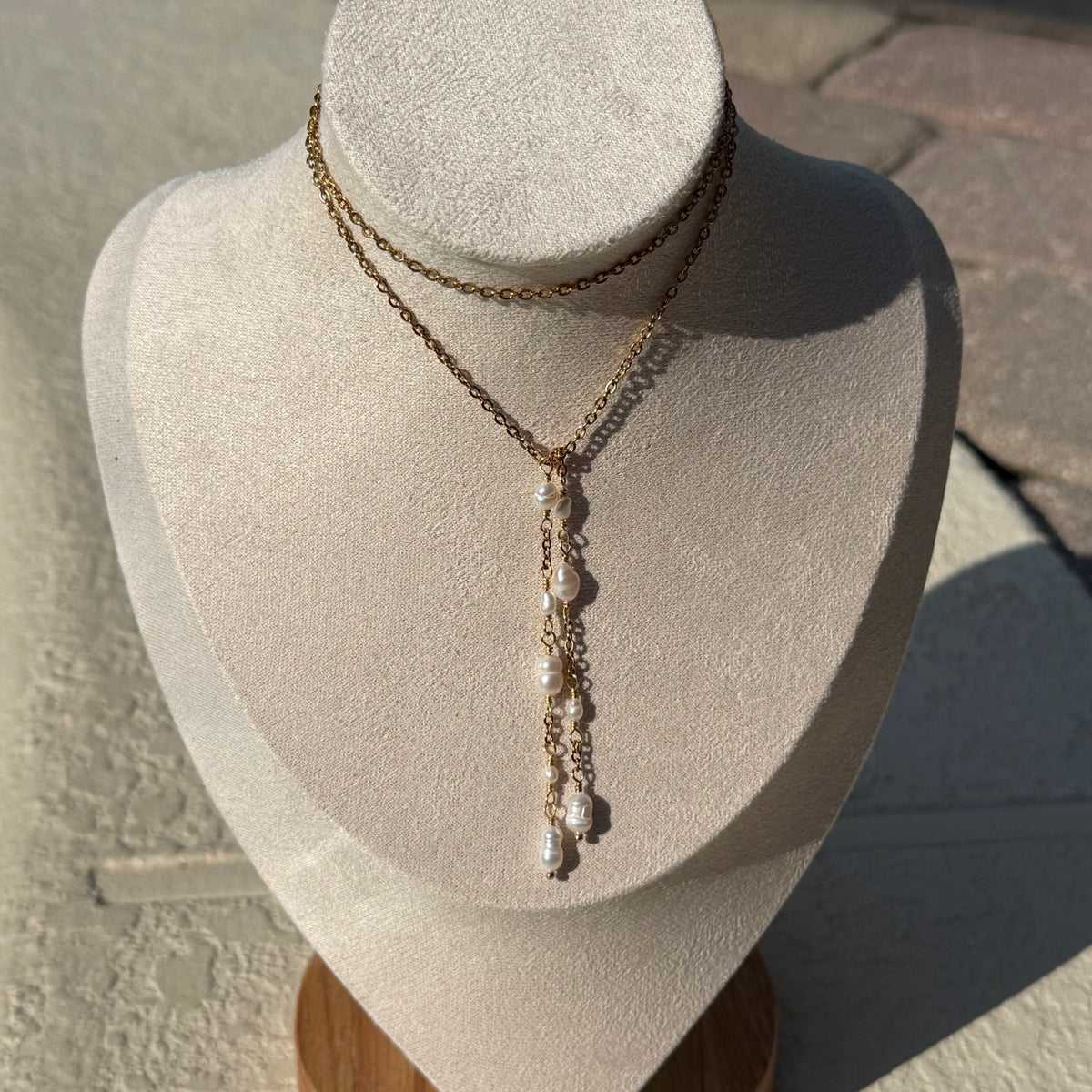 Pearl Wrap Lariat Necklace styled in a layered wrap configuration