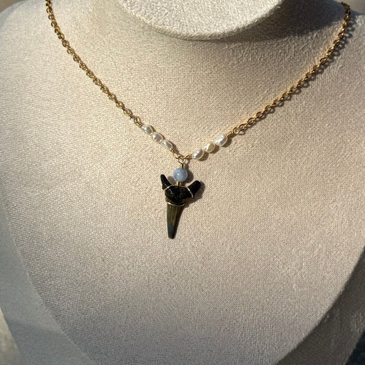 Pearl Drift Shark Tooth Necklace displayed on a jewelry bust