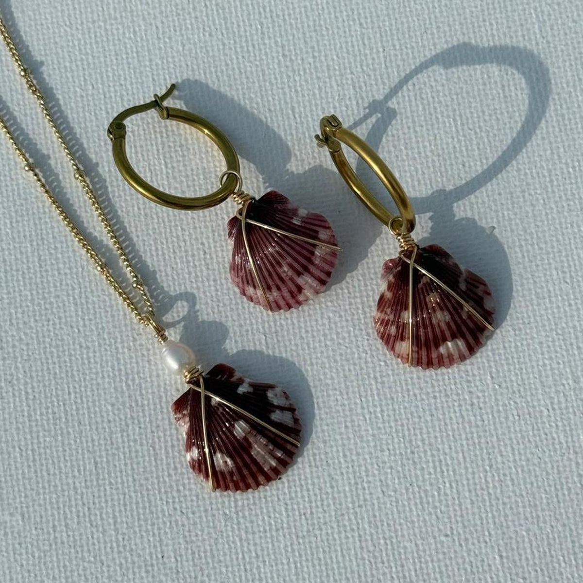 Burgundy Bay Set necklace and matching scallop shell earrings displayed together