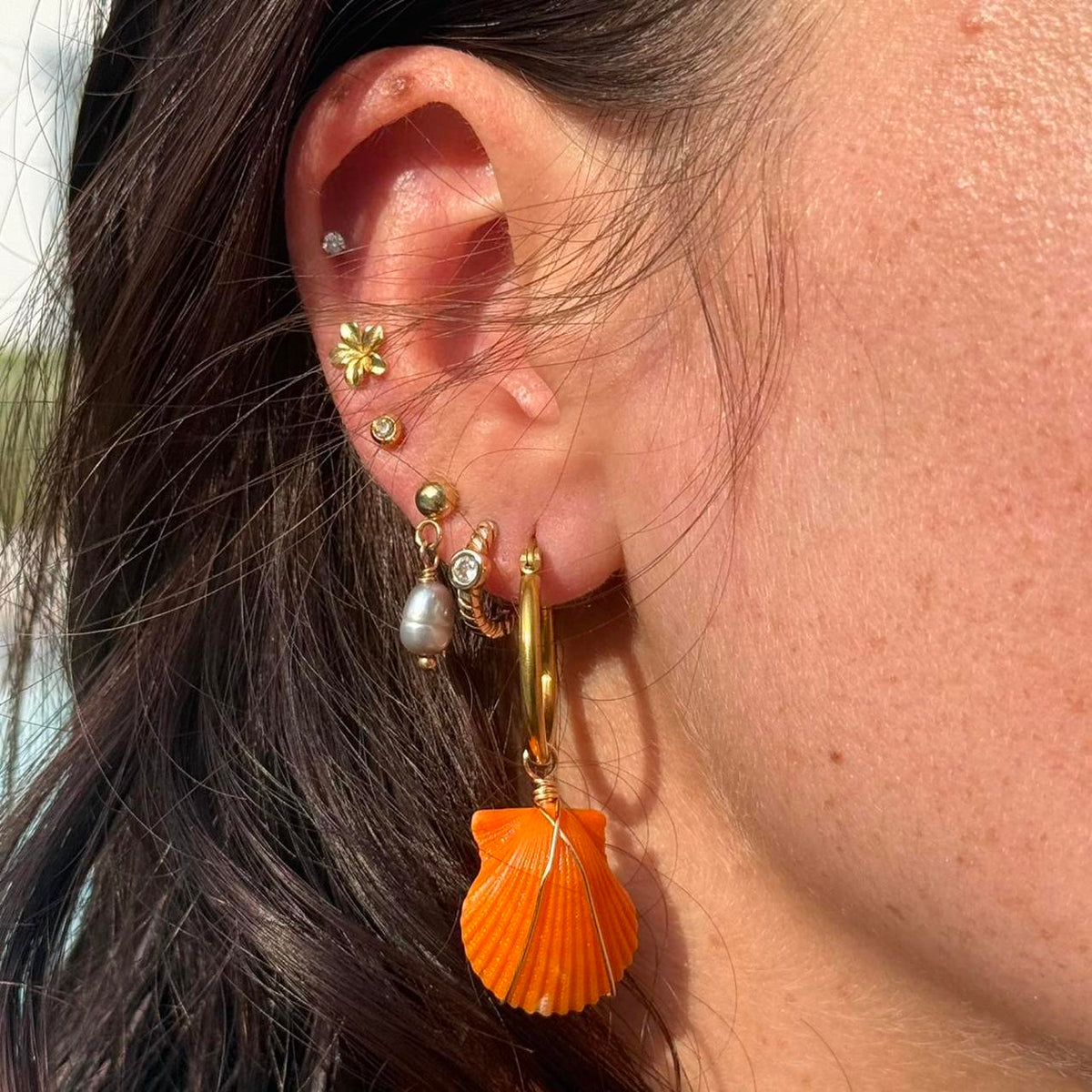 Coastal Ember scallop shell hoop earring worn