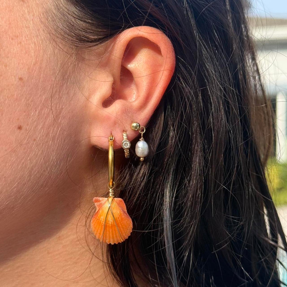 Coastal Ember orange shell hoop earring close-up