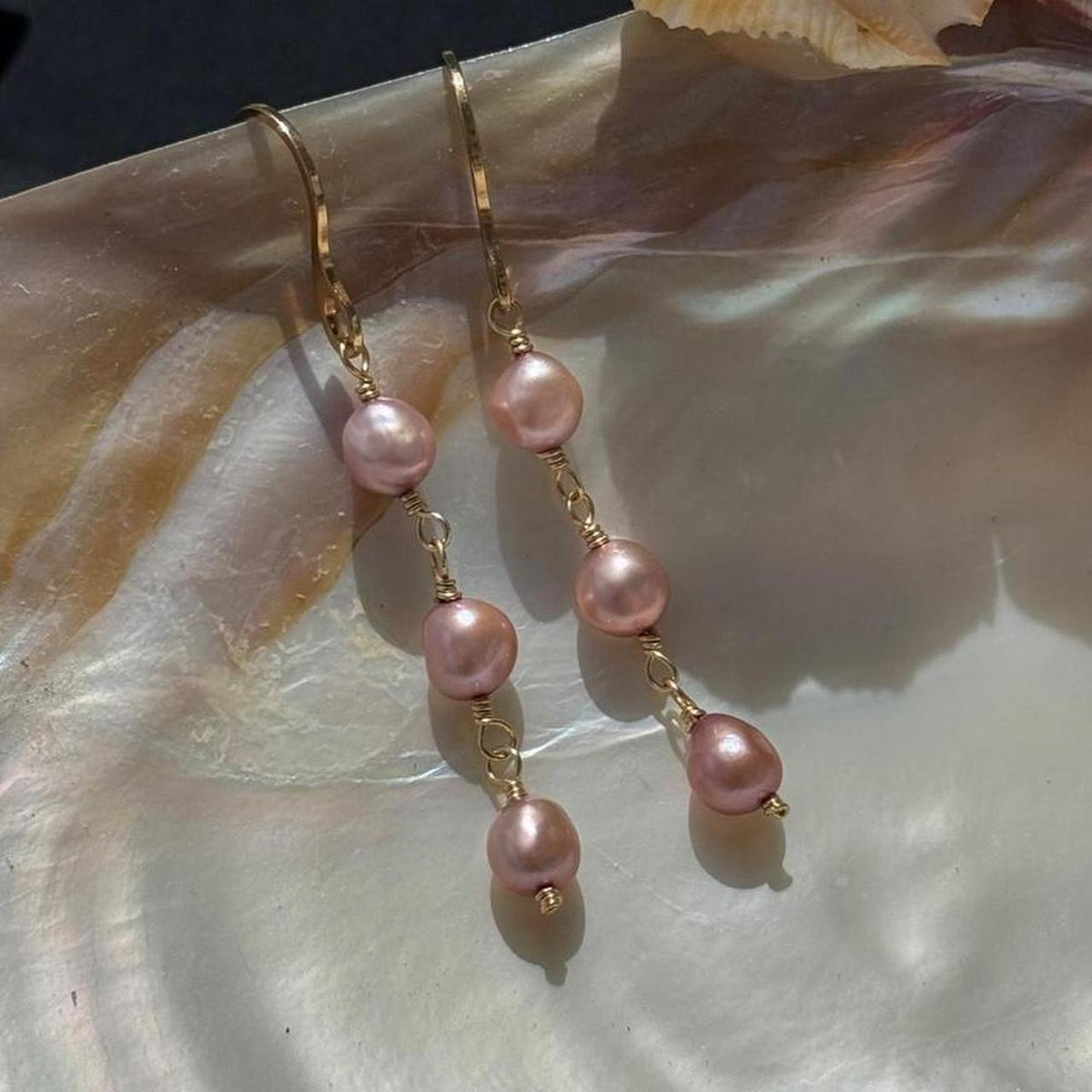 Pink pearl drop earrings in gold
