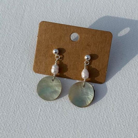 Silver Pearl Tide Earrings displayed on white fabric
