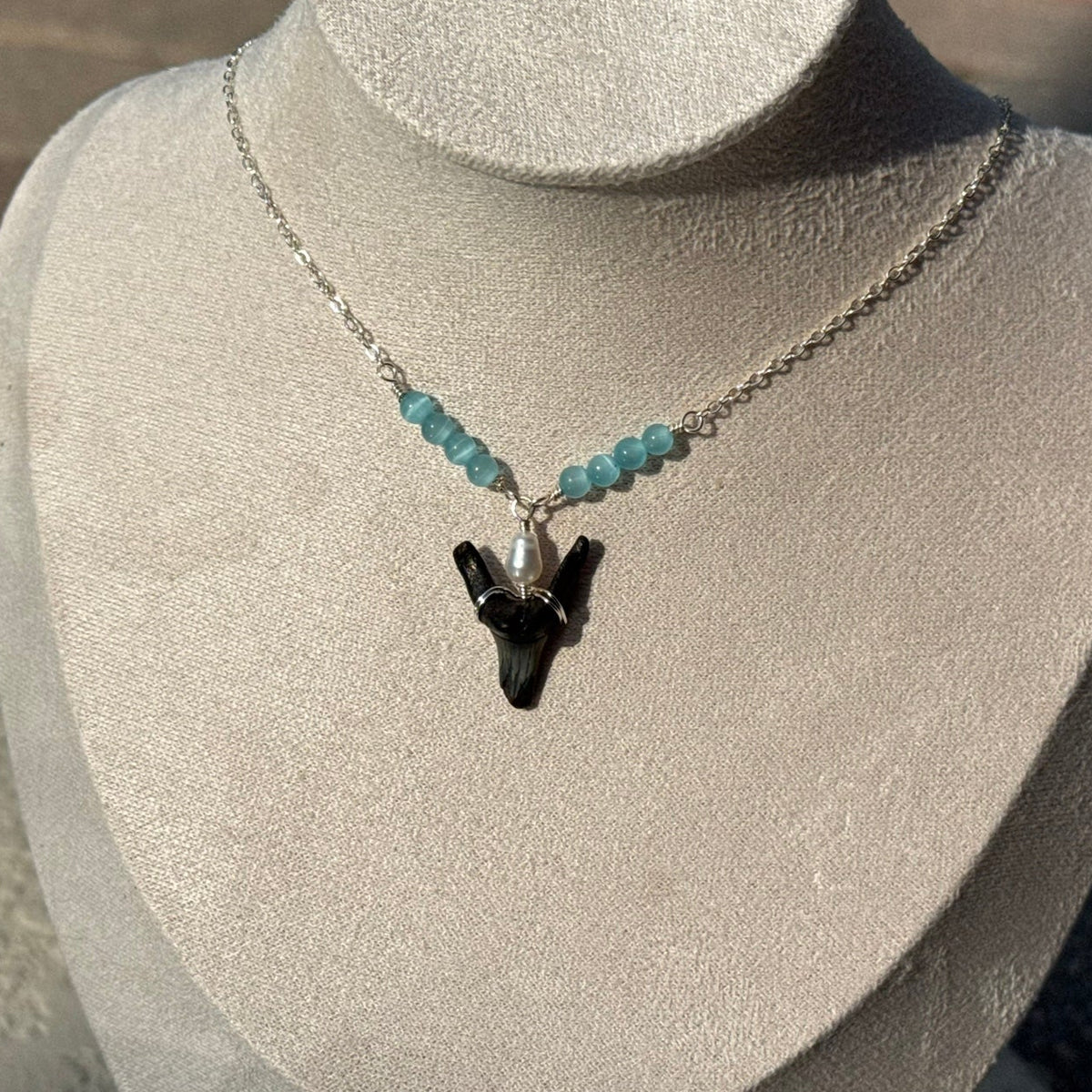Tidepool Shark Tooth Necklace displayed on a jewelry bust