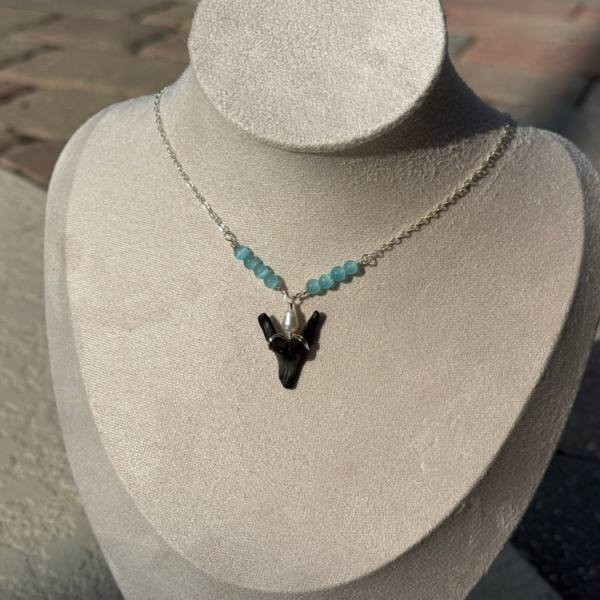 Close view of handmade shark tooth necklace
