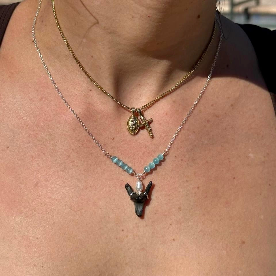 Shark tooth necklace worn as a layered coastal jewelry look