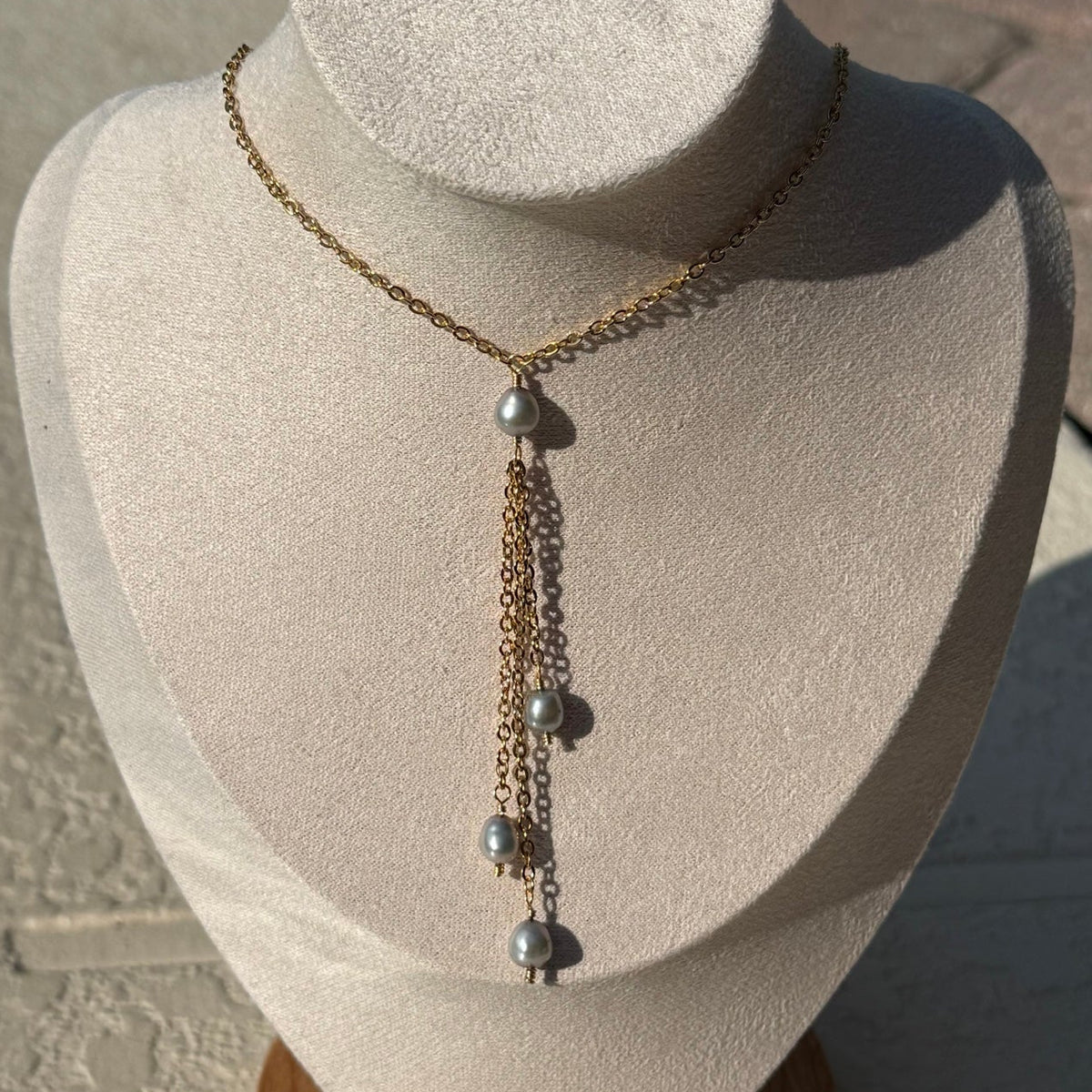 Gold-tone pearl tassel necklace with cascading chains