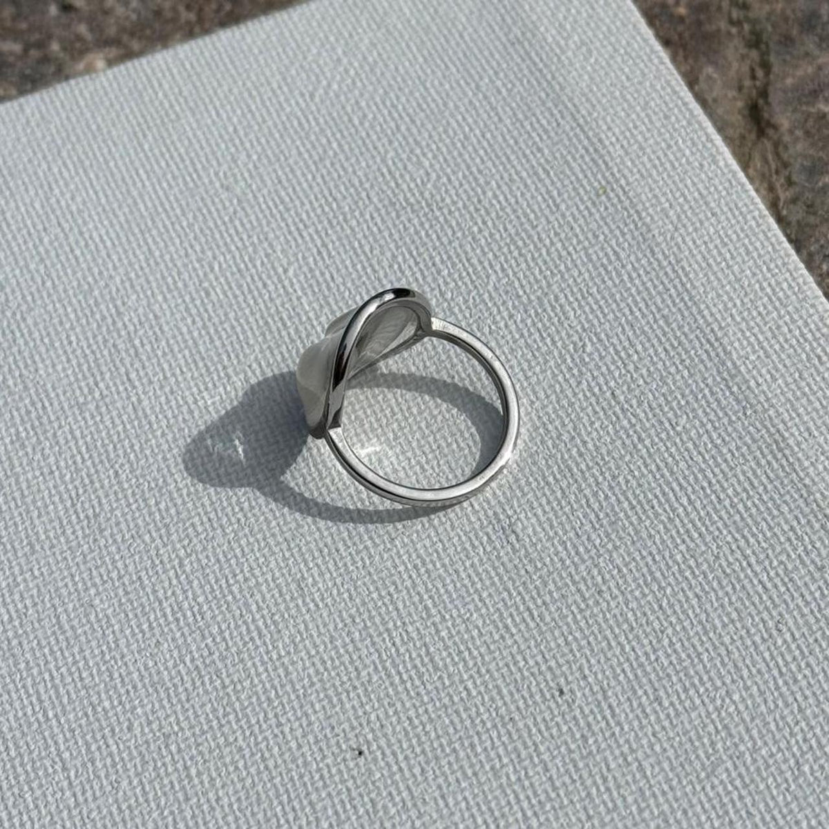 Side view of silver butterfly resin ring