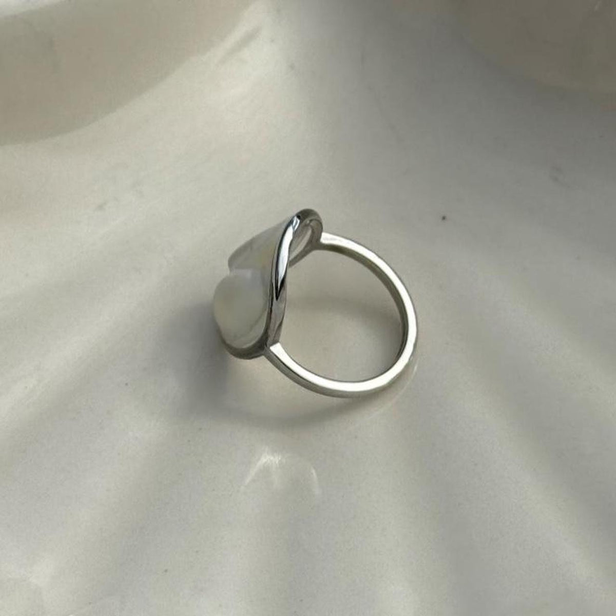 Side profile of white butterfly resin ring