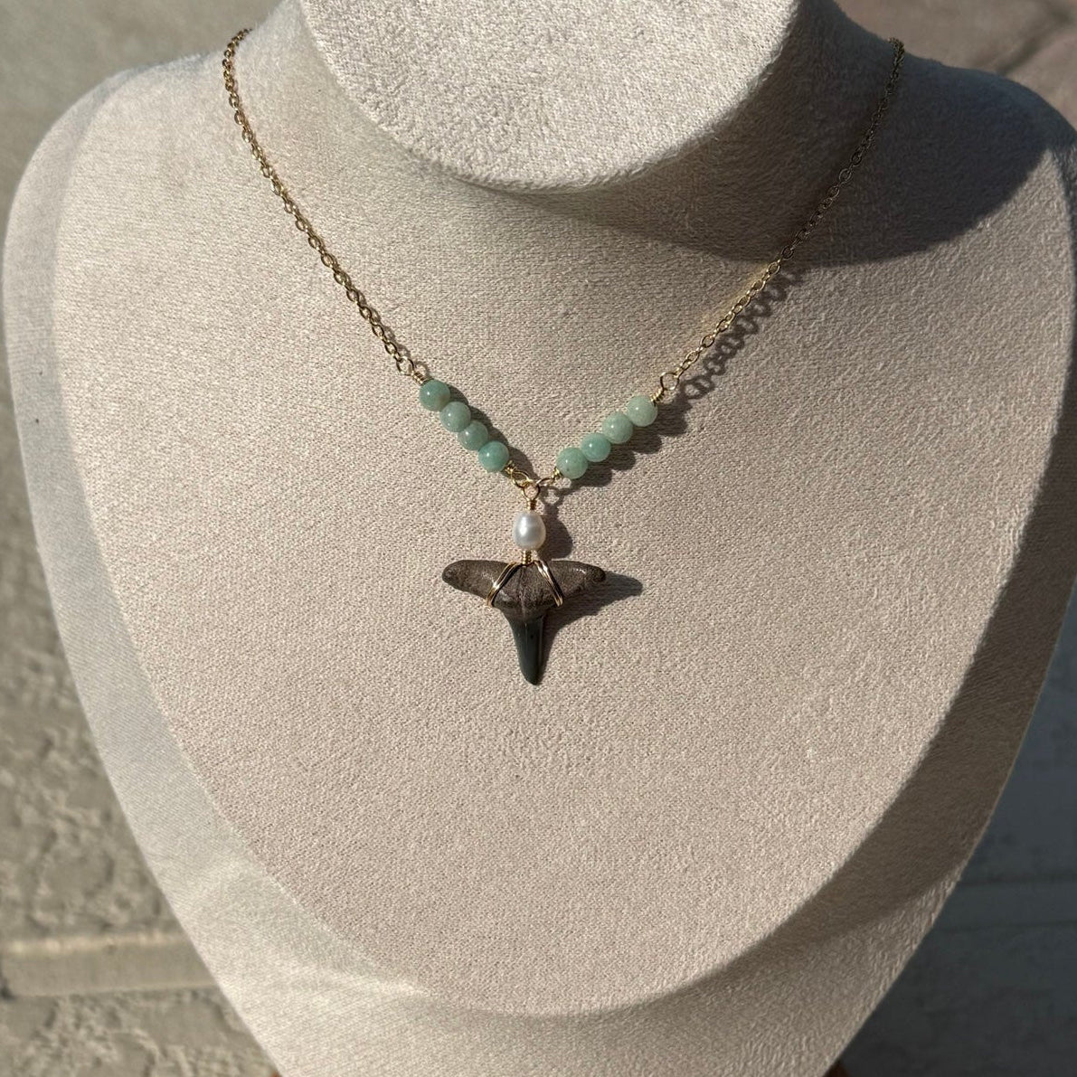 Seaglass Shark Tooth Necklace displayed on a jewelry bust