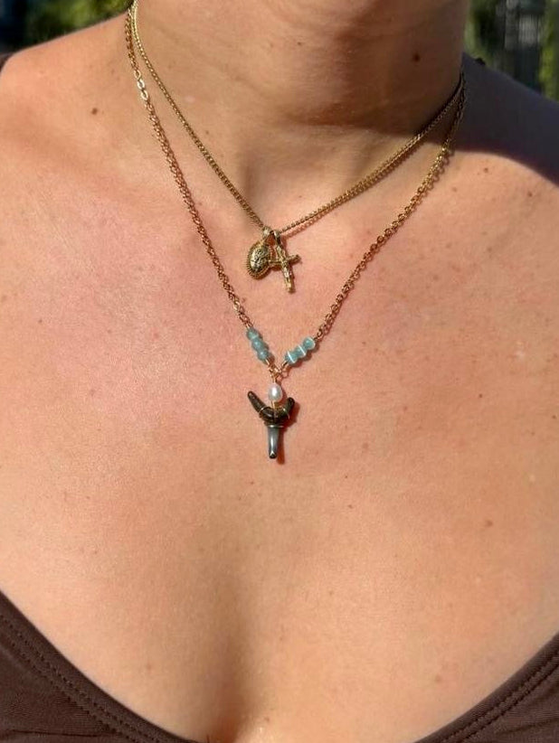 Handmade gold-tone coastal shark tooth necklace styled on model
