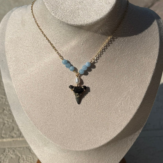 Blue Horizon Shark Tooth Necklace displayed on a jewelry bust
