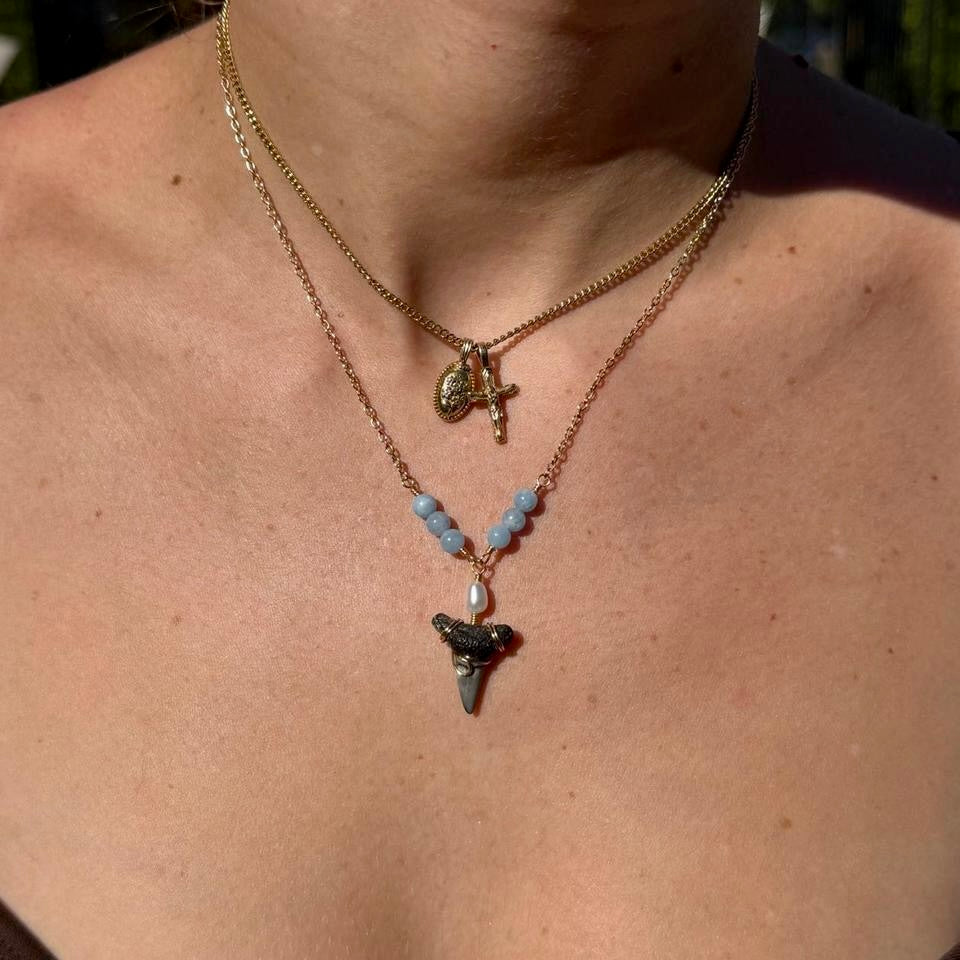 Blue and pearl shark tooth necklace worn outdoors