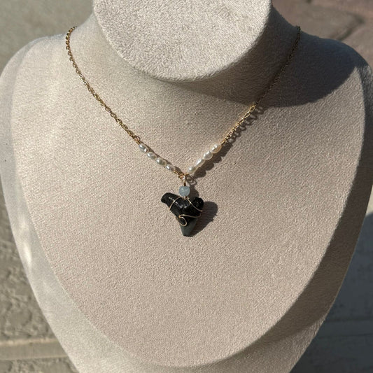 Pearl Tide Shark Tooth Necklace displayed on a jewelry bust