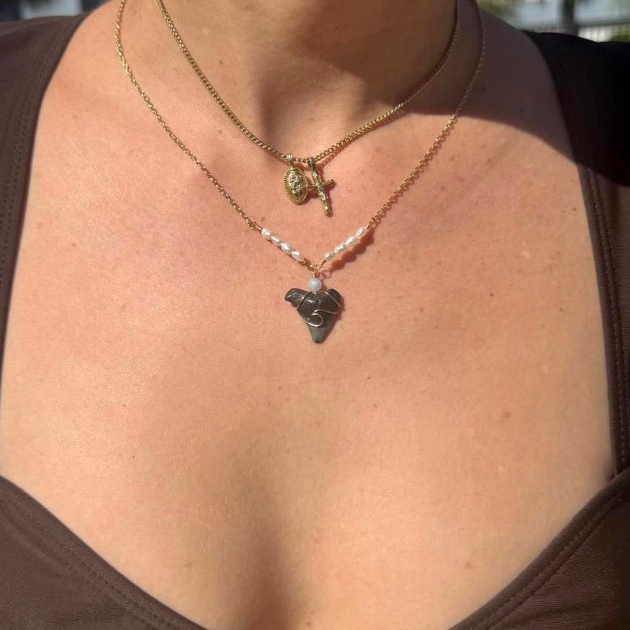 Handmade coastal shark tooth necklace styled on model