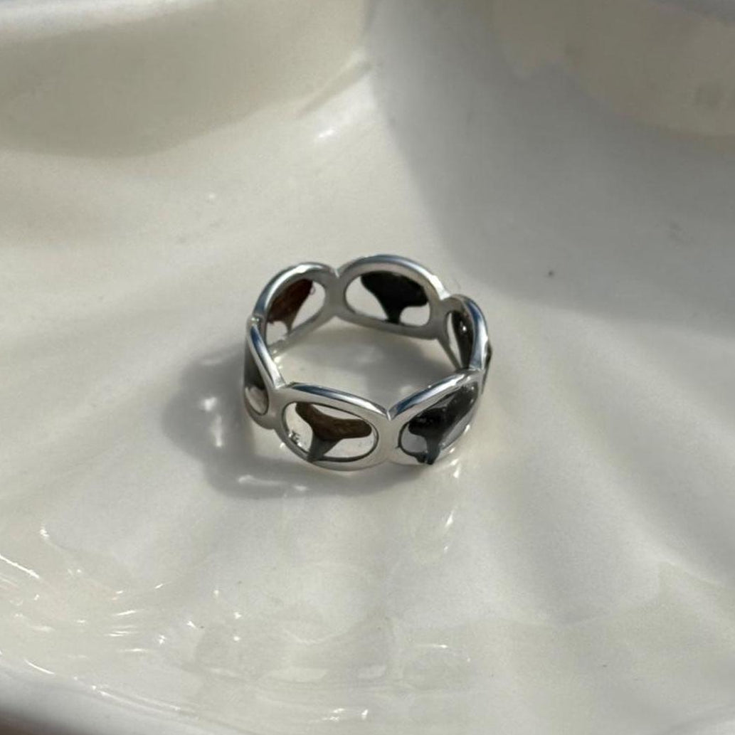 Silver-tone shark tooth ring displayed in sunlight