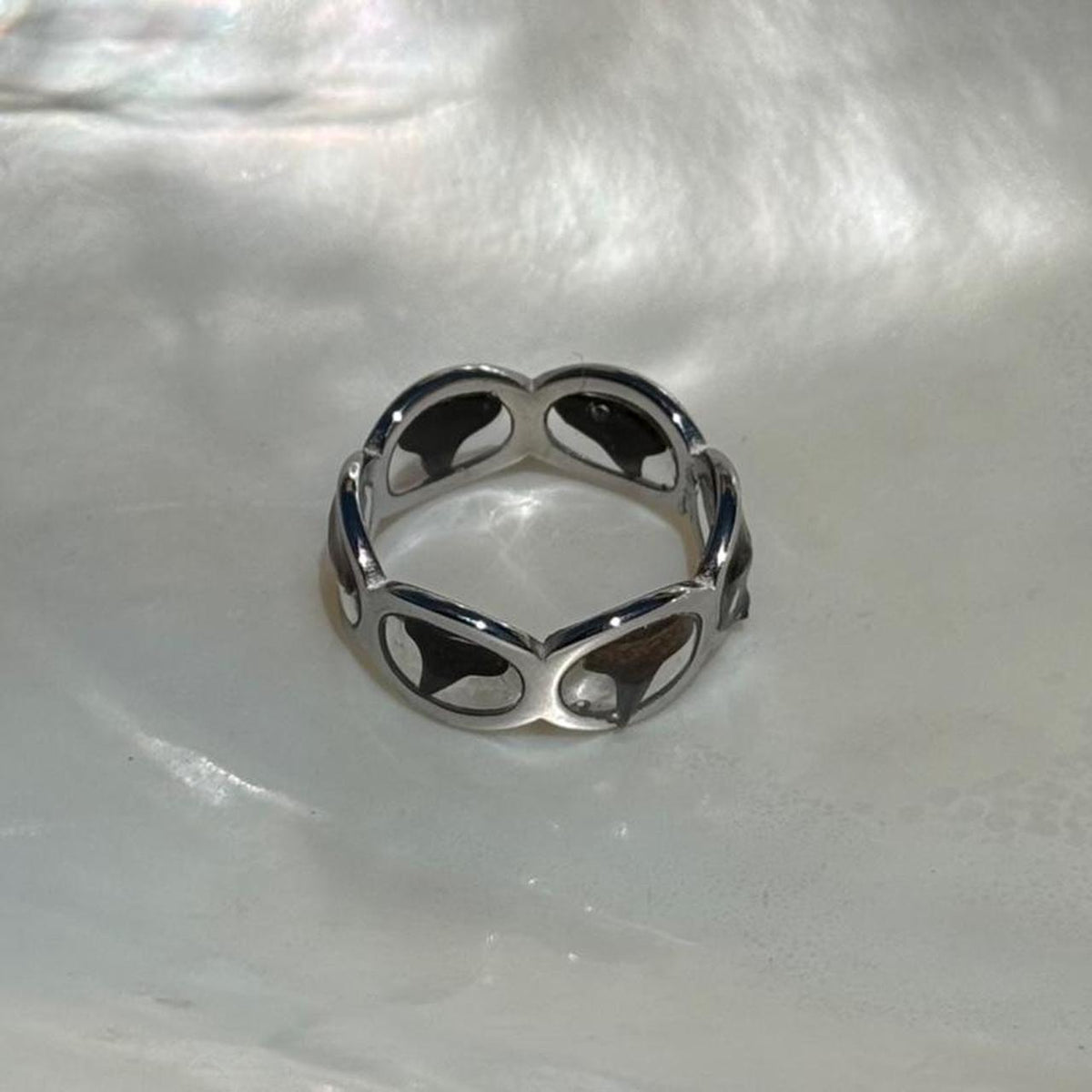 Close view of genuine shark teeth set around silver-tone ring